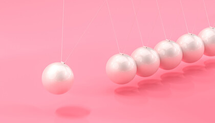 newton's pendulum with pearl marbles and pink background.