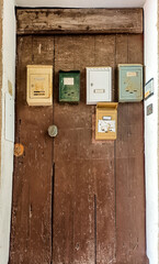  Local architecture and details of houses in the medieval old town of Ventimiglia in Italy, Liguria in the province of Imperia. Antique door letter-boxes in an old house
