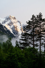 Beautiful mountain landscape. Alpine climbing. Sunset in the mountains. Dramatic clouds. The Caucasus is a region spanning Europe and Asia. Elbrus region. Aerial view to the mountains in summer. 
