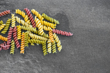 Background of multi-colored pasta close-up, top view