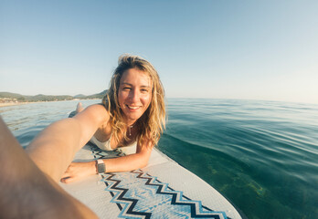 Woman taking selfie on paddle board