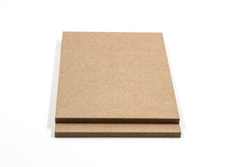 Two brown mdf boards, exposed on a white background.