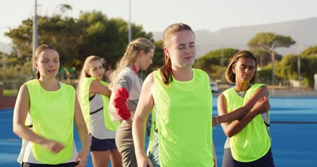 Group of girl hockey players stretching and warming up during training as their coach observes. Athletic and diverse young female teammates preparing for a game with PE teacher during exercise class - Powered by Adobe