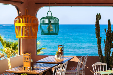 Eating concept with beautiful greek restaurant tables by the sea - 513596752