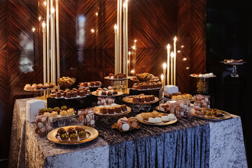 A candy bar with sweets in chocolate tones for a party	