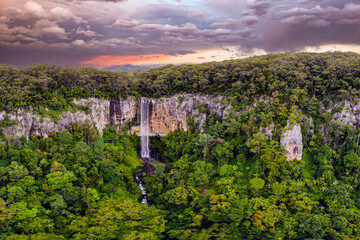 Stunning landscape view in Springbrook National Park at sunset with cascading Purling Brook Falls...