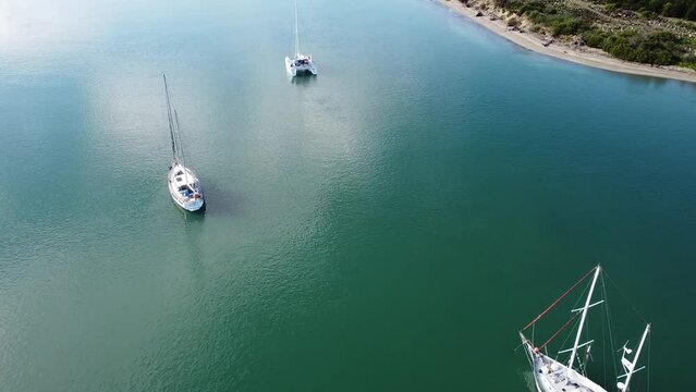 2.7K Aerial shot of sailboats with shallow clear water on a sunny day