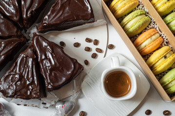 Early morning breakfast with coffee and macaroons on white concrete table.Life style.