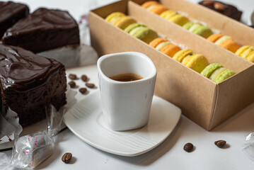 Early morning breakfast with coffee and macaroons on white concrete table.Life style.