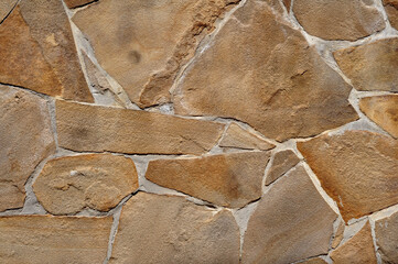 Yellow stone limestone texture, irregular shape and natural lines. Retaining wall