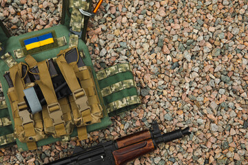 Military body armor and a Kalashnikov assault rifle. Body armor with combat butts. Ukrainian army....