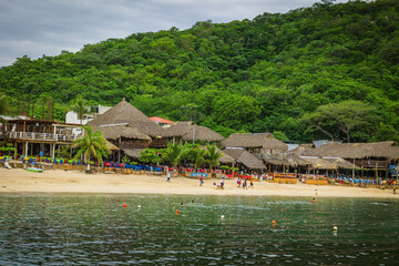 Huatulco bays - "La Entrega" beach. Beautiful beach with pristine waters, with turtles and fishes. Mexican beach with wooden huts by the sea