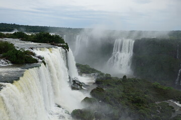 Fototapeta premium The photo shows a stunning view from the top of the Iguazu Falls — a complex of 275 waterfalls on the Iguazu River, located on the border of Brazil and Argentina.