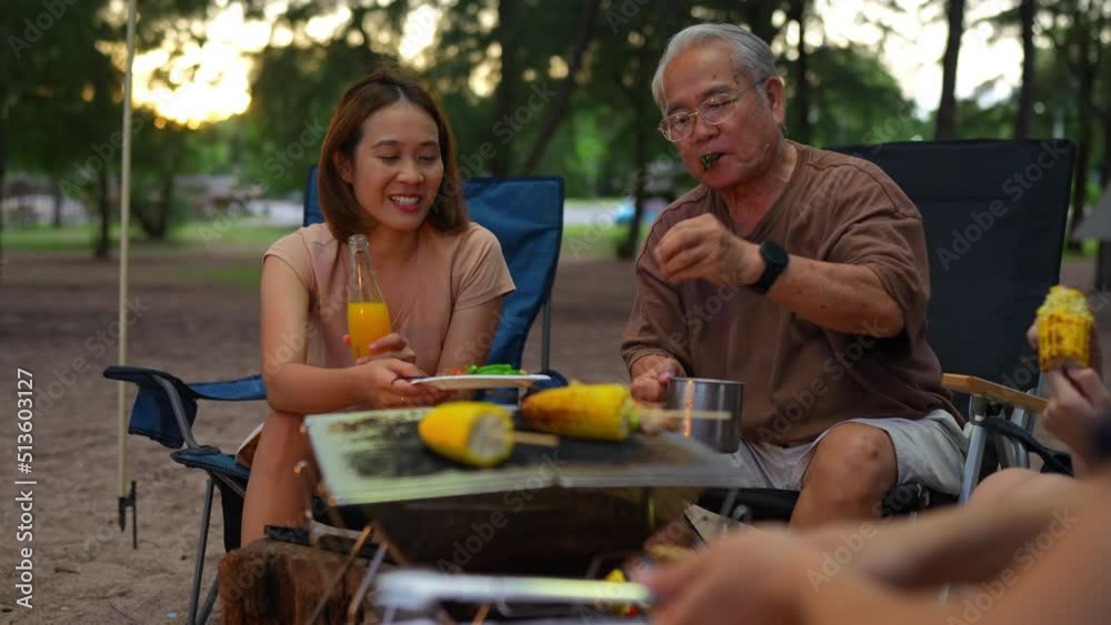 Wall mural Happy family preparing barbecue together, Cooking grilled bbq dinner outside beach, enjoy summer on the beach enjoy on weekend people lifestyle.