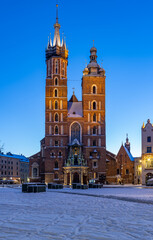 St Mary's church on snow covered Main Square in winter Krakow, illuminated in the night. - 513604313