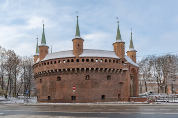 Fototapeta premium Medieval Barbicane, part of Krakow fortification, on snowy morning, Poland