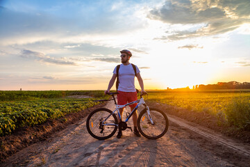 cyclist riding a bike at sunset, active lifestyle. The concept of extreme cycling, free space.