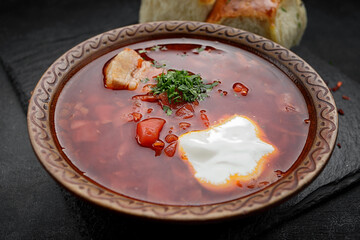 Red borscht with buns with garlic and sour cream