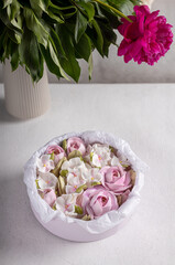 Obraz na płótnie Canvas Zephyr bouquet of flowers in box on a gray background