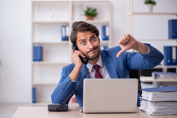 Fototapeta premium Young male employee and too much work in the office