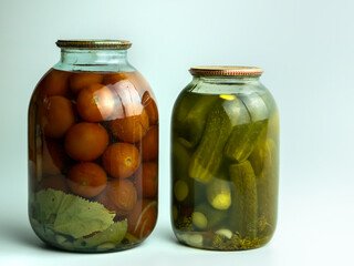 Cucumbers and red tomatoes in the pot isolated on white background