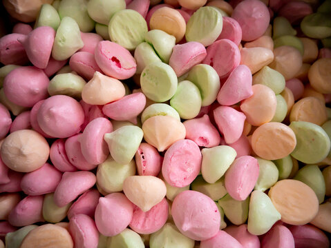 many bize, multi-colored sweets, airy cakes background