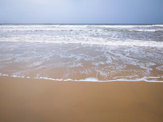 Fototapeta na wymiar waves on the beach in summer