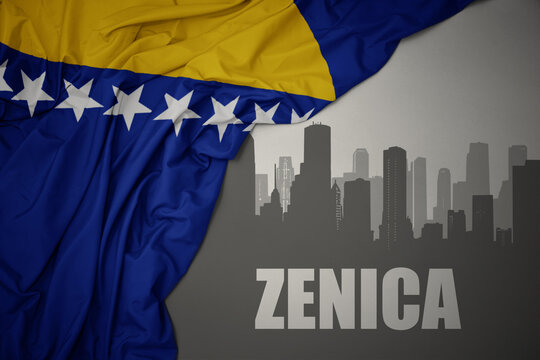 abstract silhouette of the city with text Zenica near waving national flag of bosnia and herzegovina on a gray background.