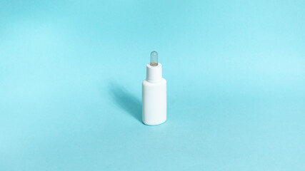 One white tube of skin care cosmetics on blue background. The concept of face and body skin care and anti-aging treatments.