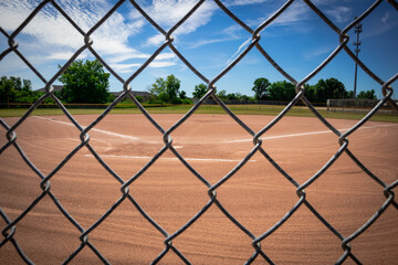Chain link fence and baseball diamond - Powered by Adobe