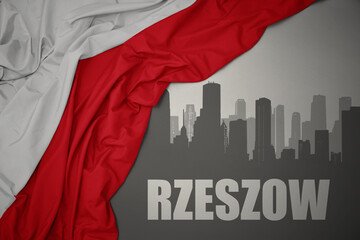 abstract silhouette of the city with text Rzeszow near waving national flag of poland on a gray background.