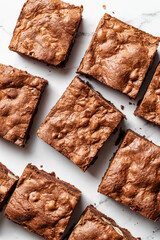 Chocolate brownie cake dessert on white marble background top view
