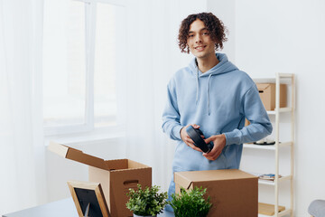 Fototapeta na wymiar portrait of a man cardboard boxes in the room unpacking in headphones Lifestyle