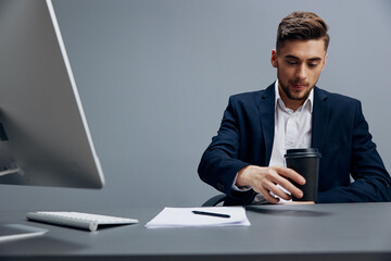 handsome businessman drinking coffee tired at work with documents on the table office