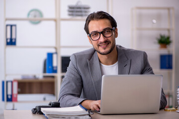 Young male employee working in the office
