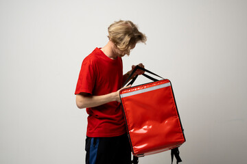 Young courier with thermo bag on white background. Food delivery service.
