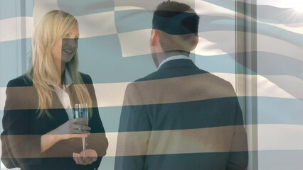 Waving greece flag against diverse businessman and businesswoman discussing at office - Powered by Adobe