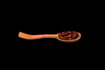 Baru seed, also known as baru nut, or chiquitania almond in wooden spoon on dark background