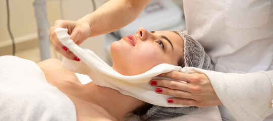 Obraz na płótnie Canvas Close up of young woman getting spa massage treatment at beauty spa salon.