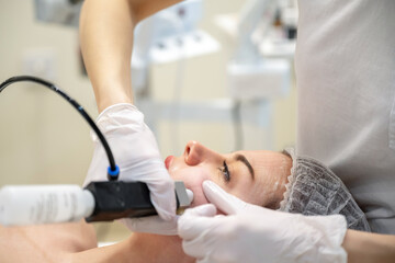 Beautiful woman getting rejuvenation treatment in beauty salon