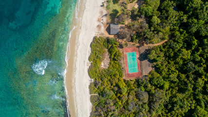aerial view of the tennis court next to the ocean
