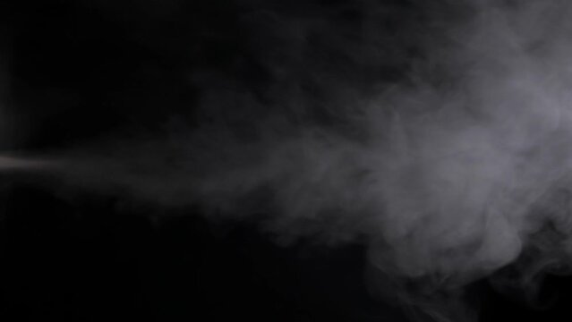 Steam or smoke rising on black background. Vertical footage. Nobody