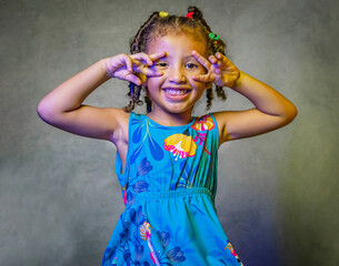 Studio portrait little girl posing with blue dress smiling beautiful happy and funny