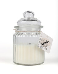 vanilla candle in a glass jar on a white background