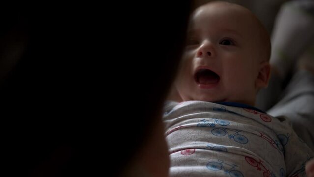 Newborn Baby With Young Mom look Into Each Other Eye. Cute Smiling Teethless Kid Face Portrait. Woman Kissing With Child Look At Camera. Infant, Mother Day, Childbirth, Beginning, Relationship Concept