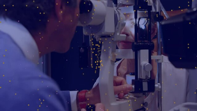 Animation of yellow dots moving over caucasian male eye doctor testing patient