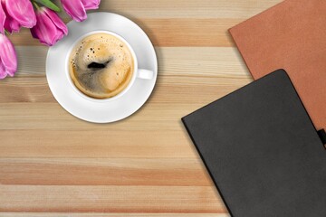 Morning coffee and notebooks on a wooden table,