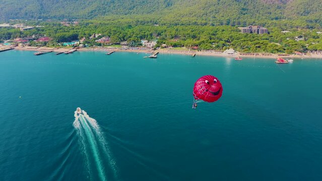 red parasailing and blue water