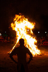 Man looking at the bonfire on the night of San Juan the shortest night of the year