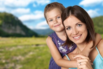 Fototapeta premium Happy mother having fun with her daughter outdoor